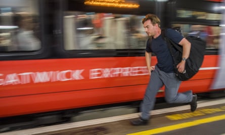 A man running for the Gatwick Express train at London Victoria station