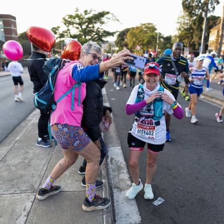 Supporters take photos with a runner in Pinetown