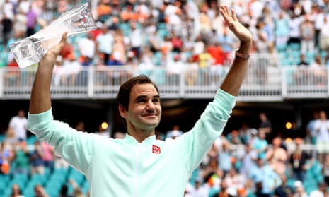 Roger Federer of Switzerland poses with the winners trophy after defeating John Isner in straight sets.