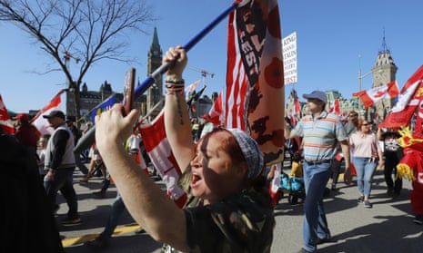 A person takes part in a demonstration in front of Parliament Hill, part of a convoy-style protest in Ottawa in April,