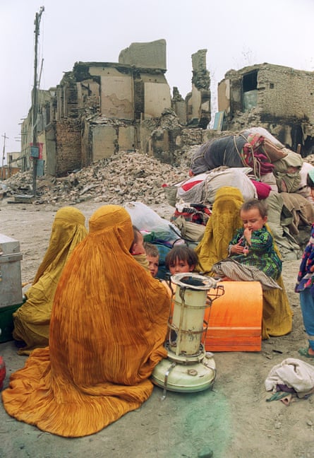 Women and children among ruined buildings in Kabul in 1992.