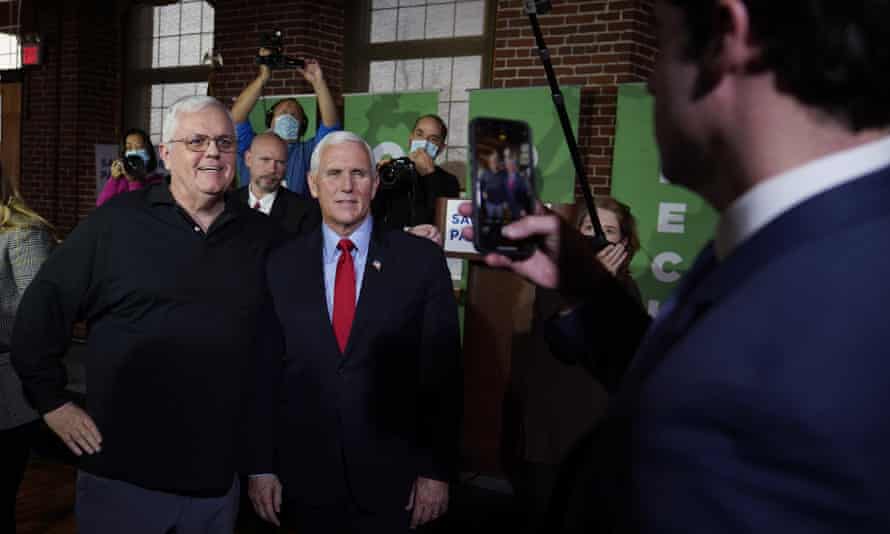 Mike Pence poses for photos with guests during a gathering in Manchester, New Hampshire, on 8 December.