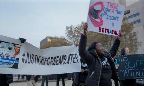 A protest of Sean Suiter’s death in The Slow Hustle.