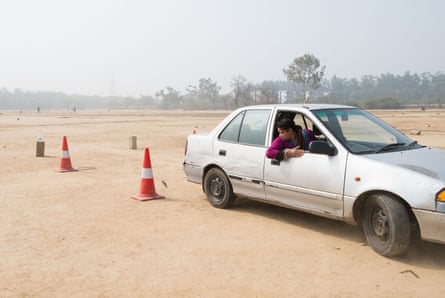 Twenty-eight-year-old Pushpa tries to park the car within the red cones during a reverse parking exercise.