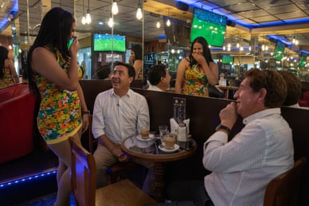 Mariam serves two regulars at Kako’s Express in Santiago, Chile.