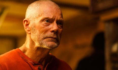 Evasive and shifty-eyed … Stephen Lang as Old Man, with close-cropped hair and beard, wearing a red vest and staring into the distance.