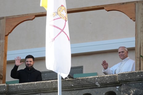 Ukraine President Volodymyr Zelenskyy and Pope Leo XIV wave to journalists during their meeting in Castel Gandolfo, Italy.