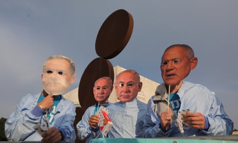 Israelis wear masks depicting  Benjamin Netanyahu and Benny Gantz during a protest
