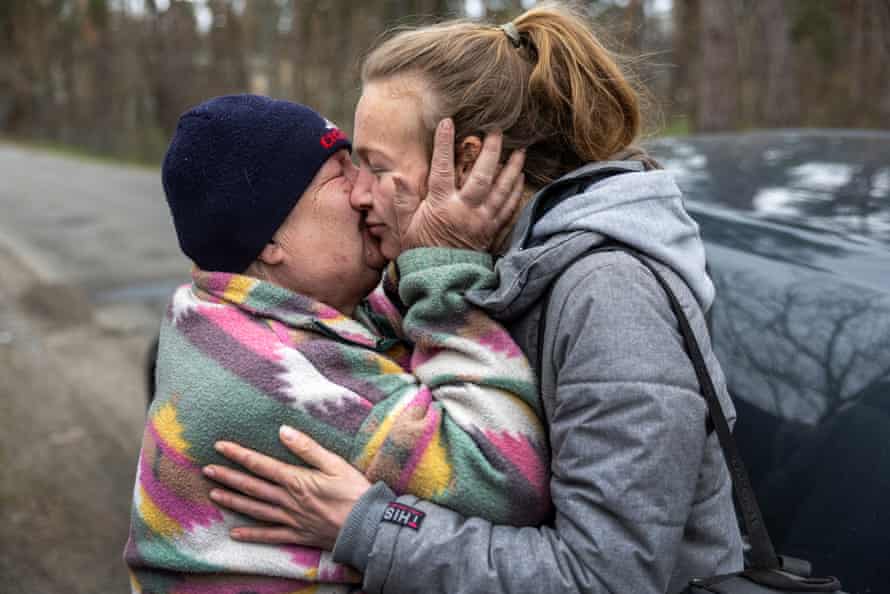 Two women embrace after returning to Bucha, Ukraine.