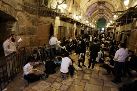 Jewish visitors pray in an indoor hallway at the entrance of the al-Aqsa mosque on 23 July.