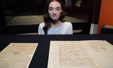 A National Archives member of staff looks at the Monteagle letter (left), and the signed declaration of Guy Fawkes (right), both dating from 1605.