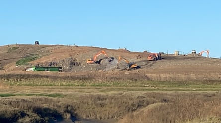 Lorries and excavators at a landfill site