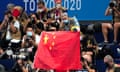 A Chinese flag is unfurled on the podium of a swimming event final at theTokyo Olympics.