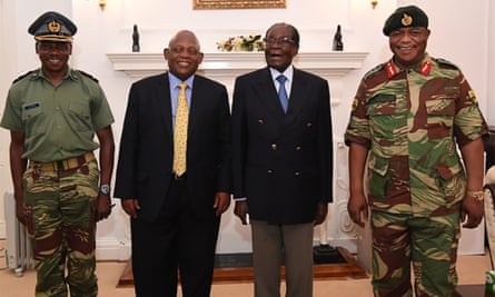 President Robert Mugabe (2R) poses alongside Zimbabwe Defence Forces Commander General Constantino Chiwenga (R) and South African envoys at State House in Harare.