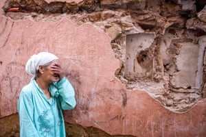 A woman reacts in front of her earthquake-damaged house in Marrakech.