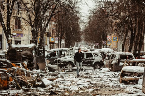 A man walks through the debris in the aftermath of Russian bombing in the besieged city of Kharkiv in northeast Ukraine.