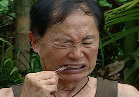 George Takei grimacing as he tries to chew something