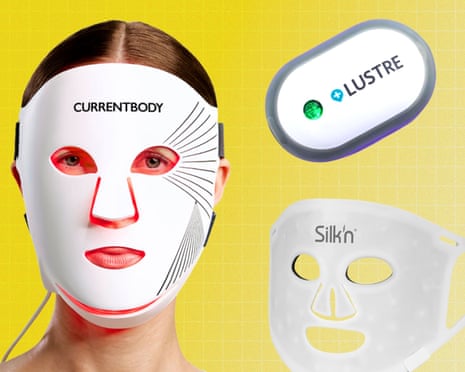 A woman wears a white LED face mask, alongside two other LED skincare devices