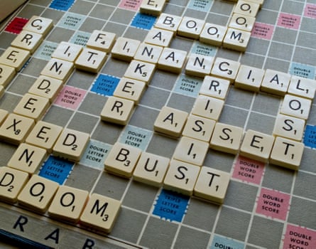 A Scrabble board spells out key words such as doom and bust