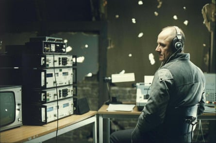 Still from The Lives of Others showing Stasi agent listening to someone on a radio