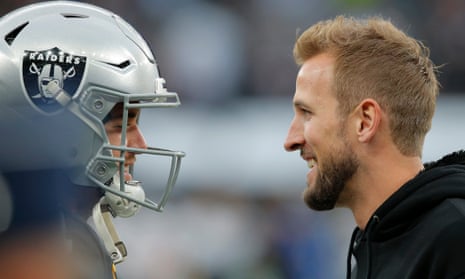Raiders quarterback Derek Carr talks to England and Spurs striker Harry game before an NFL game in 2019. Kane is a big NFL fan but may be too busy to watch in the coming weeks