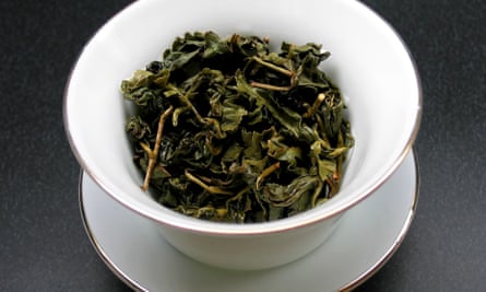 Dry leaves of green tea in a cup