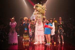 Designer Luke Sales (wearing blue) is hugged by his design partner Anna Plunkett at the end of the Romance Was Born show.