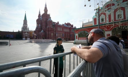 People speak with a police officer at Red Square in Moscow