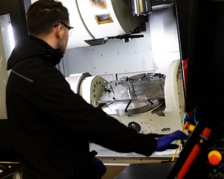 Worker making aluminium castings for car parts