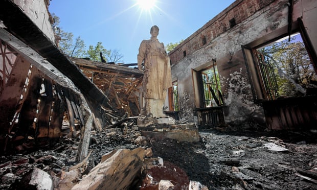A statue of philosopher Hryhorii Skovorodaamong rubble