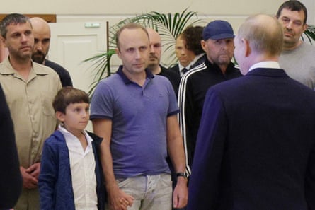 Pablo González, back left, shaved head, listens to Russian President Vladimir Putin speaking to released Russian prisoners in August.
