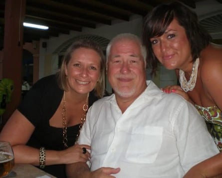Danielle Gillam-Kirton and another woman leaning in beside Pete Gillam for a group photo