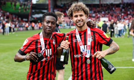Siriki Dembele celebrates promotion to the Premier League with his Bournemouth teammate Emiliano Marcondes