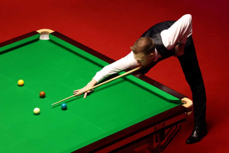 Judd Trump of England plays a shot.