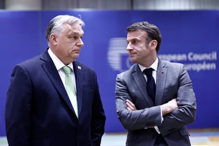 Viktor Orbán and Emmanuel Macron look at one another with antipathy