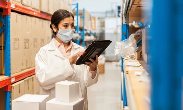 Female worker selecting spare parts in a factory store area