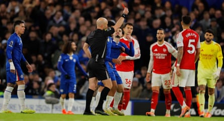 Chelsea's Moisés Caicedo is shown a red card by the referee Anthony Taylor during the Premier League match against Arsenal