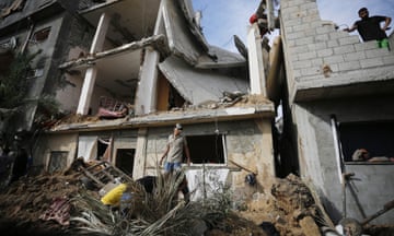 Palestinian residents carry out search and rescue operations after an Israeli attack on the Bureij refugee camp in Gaza.