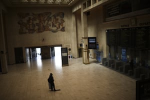 A man looks at the train departures board in a nearly empty Central station in Brussels