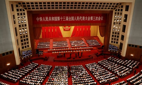 Chinese officials and delegates attend the opening session of the National People’s Congress (NPC) at the Great Hall of the People in Beijing.