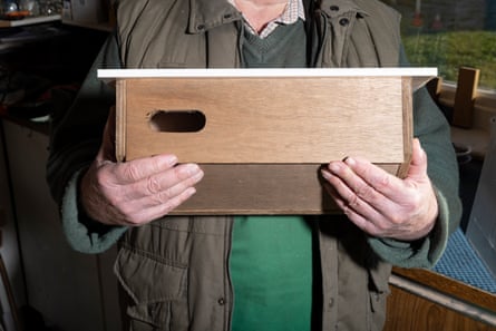 A man holds a handmade swift box