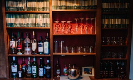 shelves with paperbacks and bottles of booze