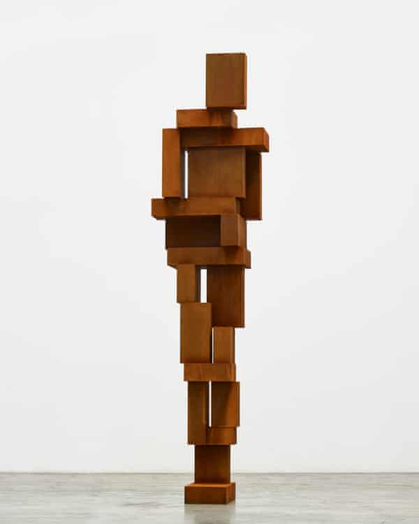 An abstract standing human figure entirely made up of rectangular metal blocks of different sizes