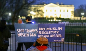 A person holds placards during a protest against Trump’s revised travel ban in March.