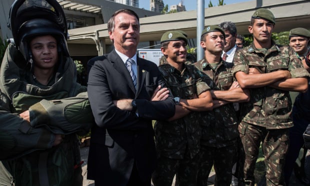 Jair Bolsonaro, who won the first round of Brazil’s presidential election on Sunday, posing with militaries during a military event in Sao Paulo, Brazil in May.
