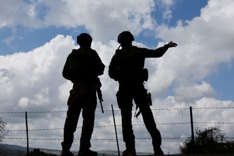 Israeli soldiers stand near the Israeli-Lebanon border.