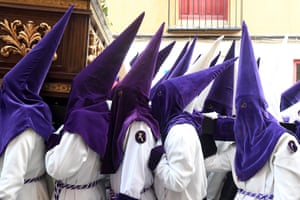 People in scary pointed hoods and white robes