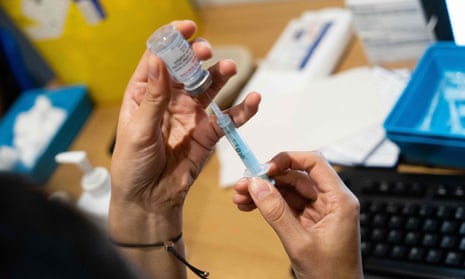 A dose of a Covid-19 vaccine is prepared in London.