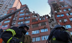 Ukrainian firefighters at an apartment building hit by a Russian missile strike in Dnipro, central Ukraine, on Friday