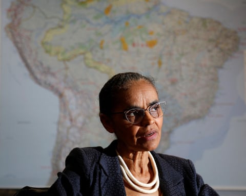 Brazil's Environment Minister Marina Silva speaks during an interview, seated before a large map